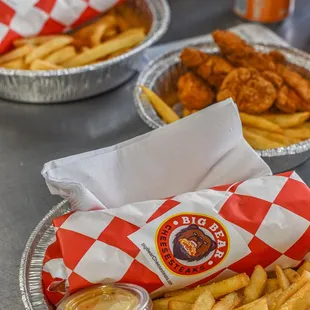 a tray of fries and a basket of chicken