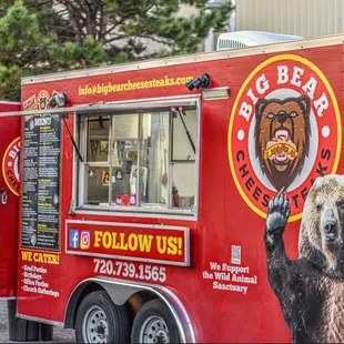 a big bear on the side of a food truck