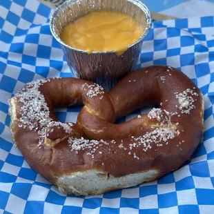 Small pretzel with cheese dip sauce