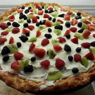 a pizza with fruit toppings