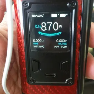 a hand holding a small electronic device