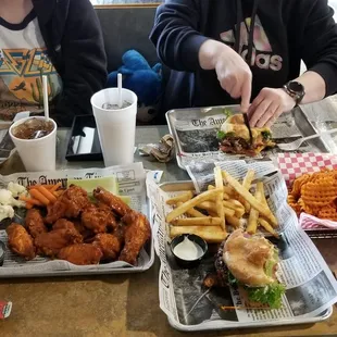 two people sitting at a table with food