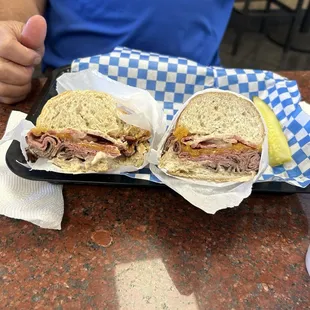 Roast beef sandwich on French bread with bacon, pickles, and all the Fixins so yummy