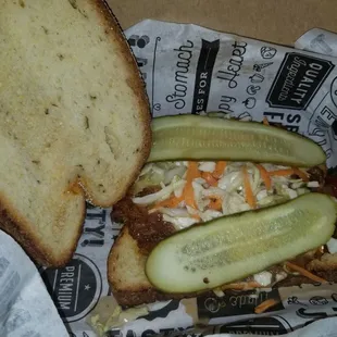 a sandwich with pickles and coleslaw