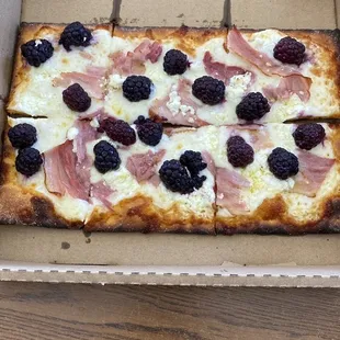 Blackberry with goat cheese and ham on sweet potato bread.