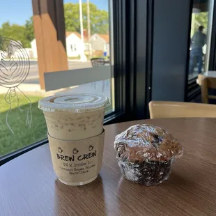 a cup of coffee and a muffin on a table
