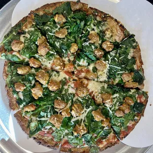 Cauliflower crust pizza with sausage and spinach