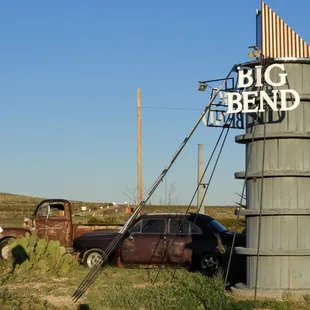 The Big Bend Pizza sign with cars for atmosphere.