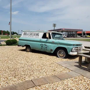 a truck parked in a gravel lot
