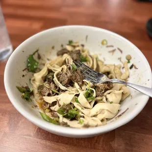 a bowl of pasta and meat