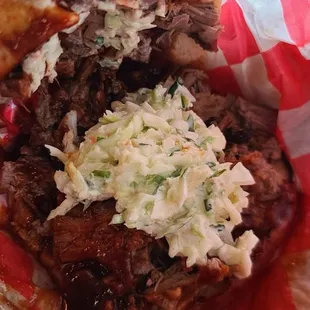 Yooo this Brisket sandwich is filled with brisket, coleslaw and hot bbq sauce!