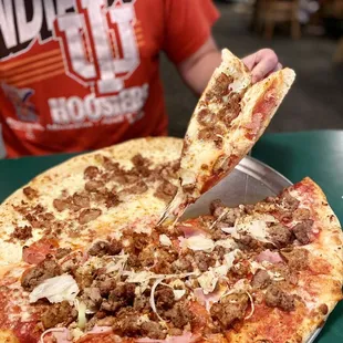 Meat pie with onions and garlic on one side and white pie with sausage on the other