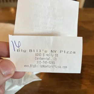 a hand holding a receipt