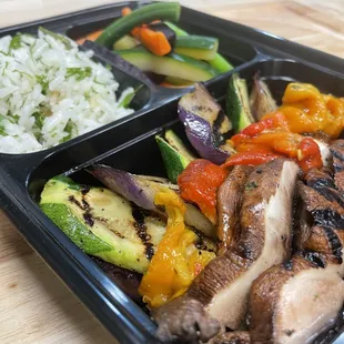 a meal of meat, vegetables and rice