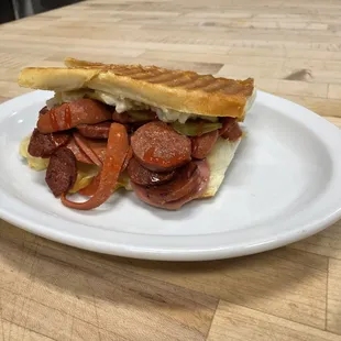 a hot dog on a white plate