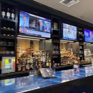 a bar with multiple televisions