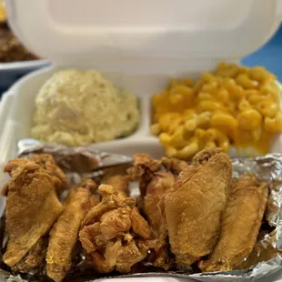 Chicken dinner with potato salad and macaroni and cheese