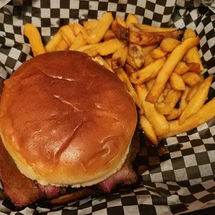 Sliced smoked brisket sandwich and fries.