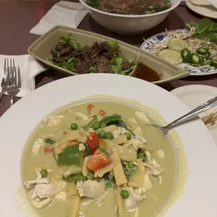 a bowl of soup and plates of food