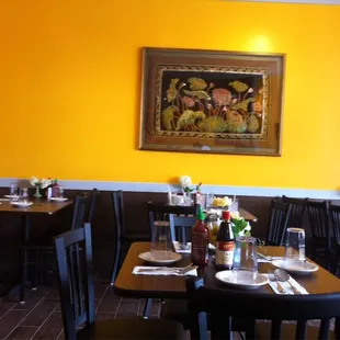 a dining area with tables and chairs