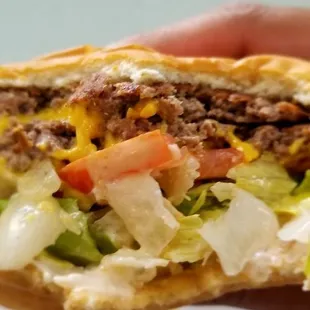 a hand holding a sandwich