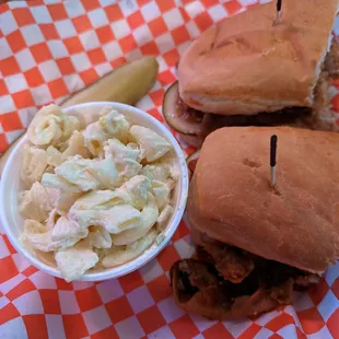 BBQ Pork Sandwich - Thinly Sliced tenderloin pork served on a french roll w/ pickles and onion + includes a side (mac salad) $13.45