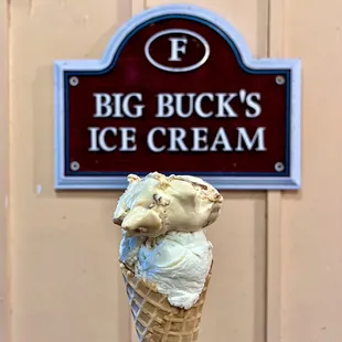 a hand holding an ice cream cone