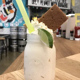 Key Lime Pie Shake -- Vanilla Ice Cream, Lime Juice Cookie Butter, Graham Cracker Crumbles, Whip, Thick Cinnamon Graham, Lime