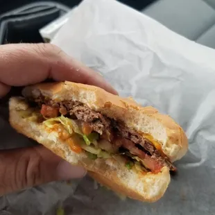  person holding a sandwich in their hand