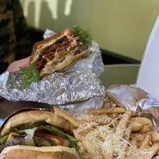 Classic burger in front, White Truffle Parmesan fries, and Pimento Cheese burger in back