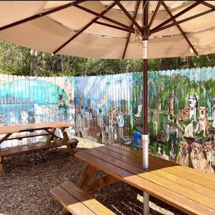 Outdoor patio with umbrellas. Bring your dog and look at the murals.