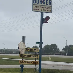 a sign for shrimp burgers and sandwiches