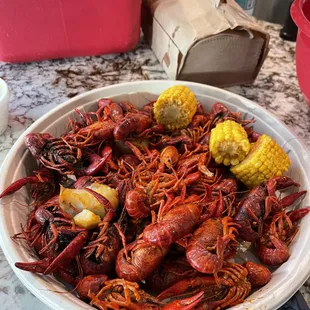 a bowl of crawfish and corn