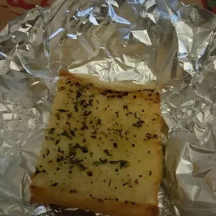 Garlic bread that comes with chicken tender meal