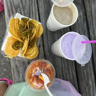 Nachos with peppers and cheese (not much at all), chocolate milkshake, unicorn milkshake, Mangonada