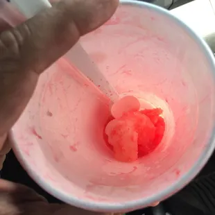 a hand holding a spoon