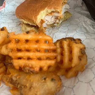 Hot and spicy chicken sandwich with waffle fries.