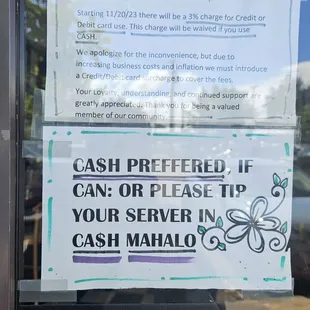 Sign on the front door indicating a 3% fee if paying by credit card