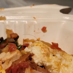 a half eaten meal in a styrofoam container