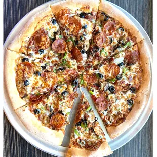 a pizza with pepperoni, olives, and cheese