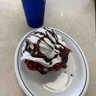 A whole bunch of delicious!!!!!! Ice cream cherry topping whipped cream chocolate syrup??