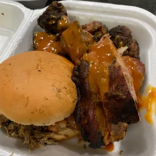 Combo platter with chopped pork sandwich ribs and chicken