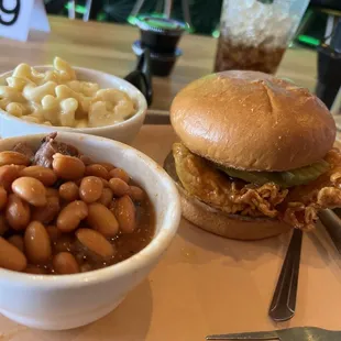 a hamburger, beans, and macaroni salad