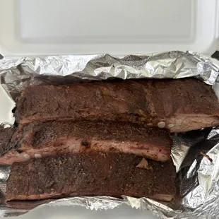 ribs in foil in a container