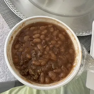 a bowl of beans in a saucer