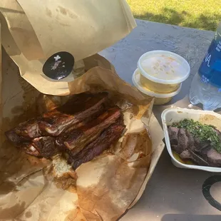 a barbecue with meat and drinks