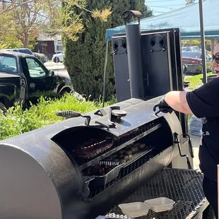 a man cooking a barbecue