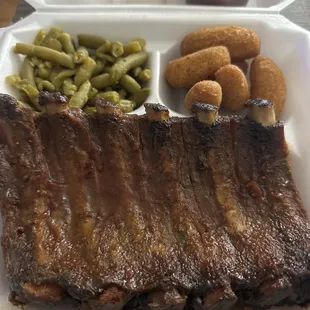 Barbecue spareribs half a rack, seasoned string beans and hush puppies