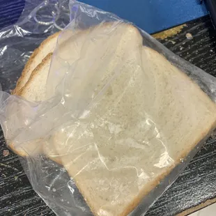 a sandwich wrapped in plastic