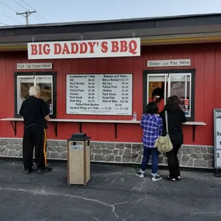 people standing outside of a restaurant